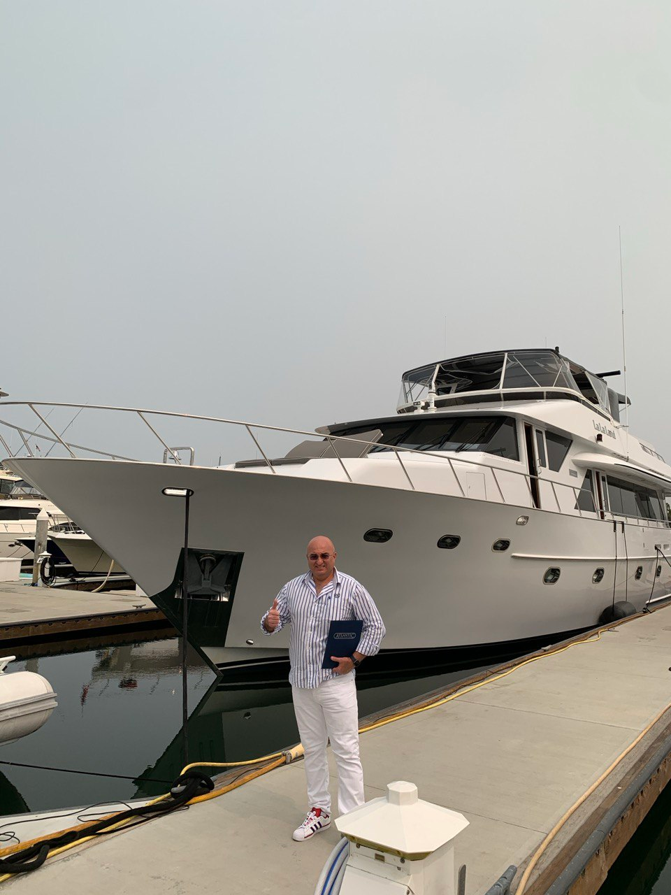 Broker Andrey Shestakov in front of the yacht
